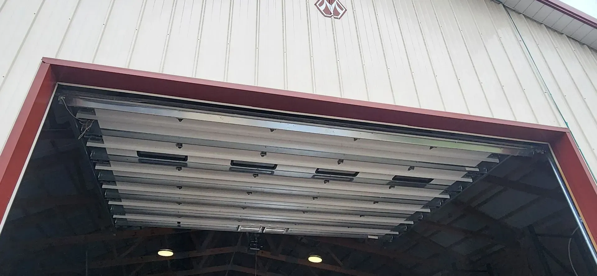 A close up of a garage door with a red trim.