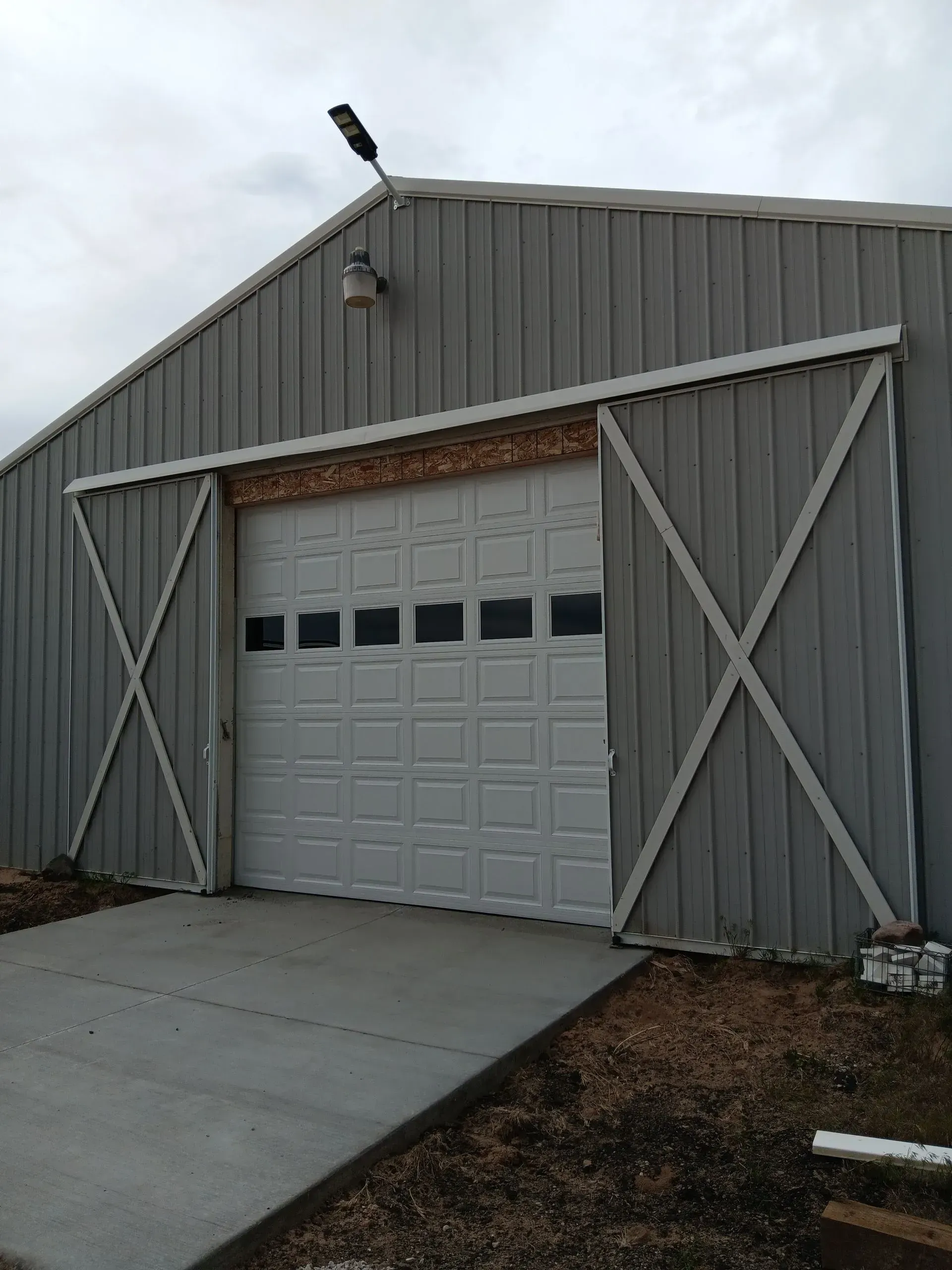 A large barn with a sliding garage door