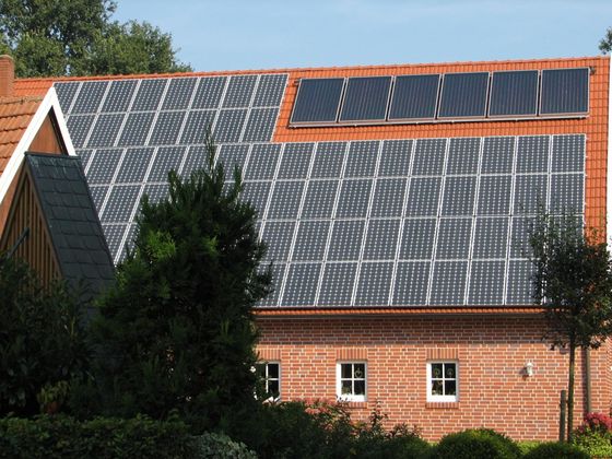 a red brick house with solar panels on the roof