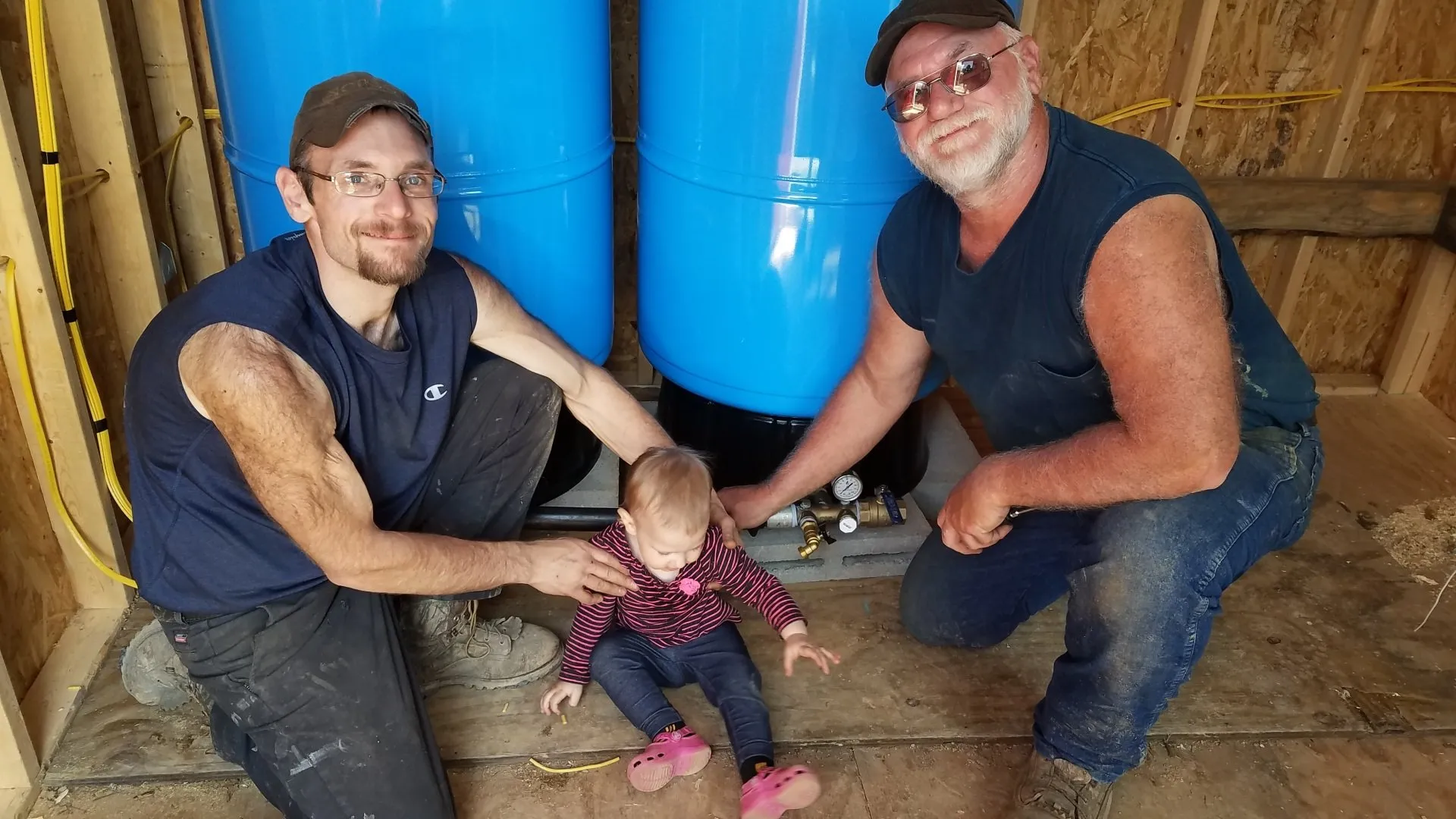 Baby having fun with her father and grandfather | Middleburg, PA | Zechman Well Drilling