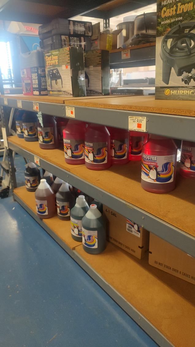 A shelf filled with lots of bottles of liquid in a store.