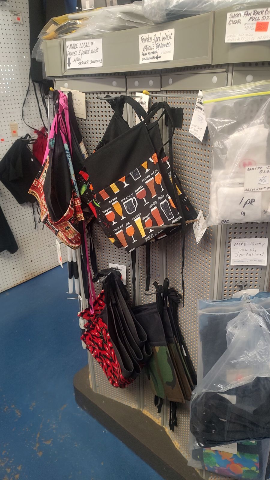A bunch of bags are hanging on a wall in a store