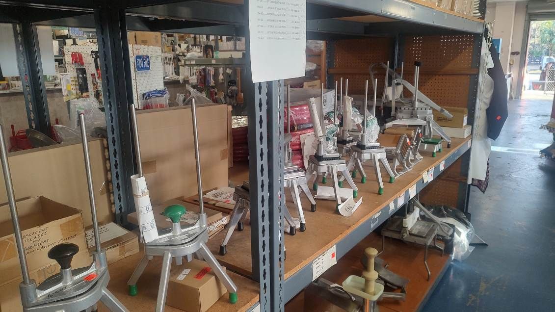 A warehouse filled with shelves filled with lots of different types of equipment.