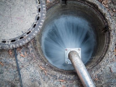 Spraying Water in Man Hole — Pembroke, MA — Drain Shooter
