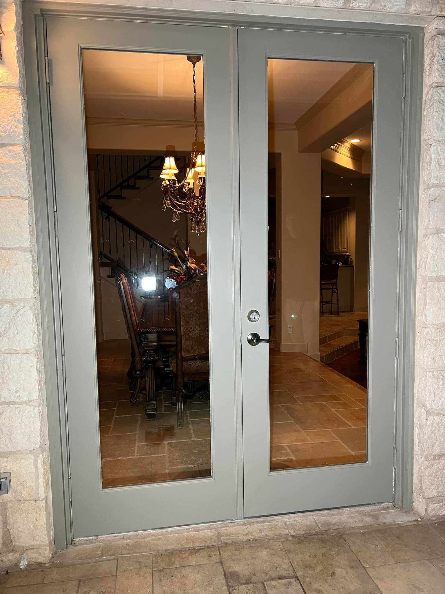 Gray double doors with large glass panels, 