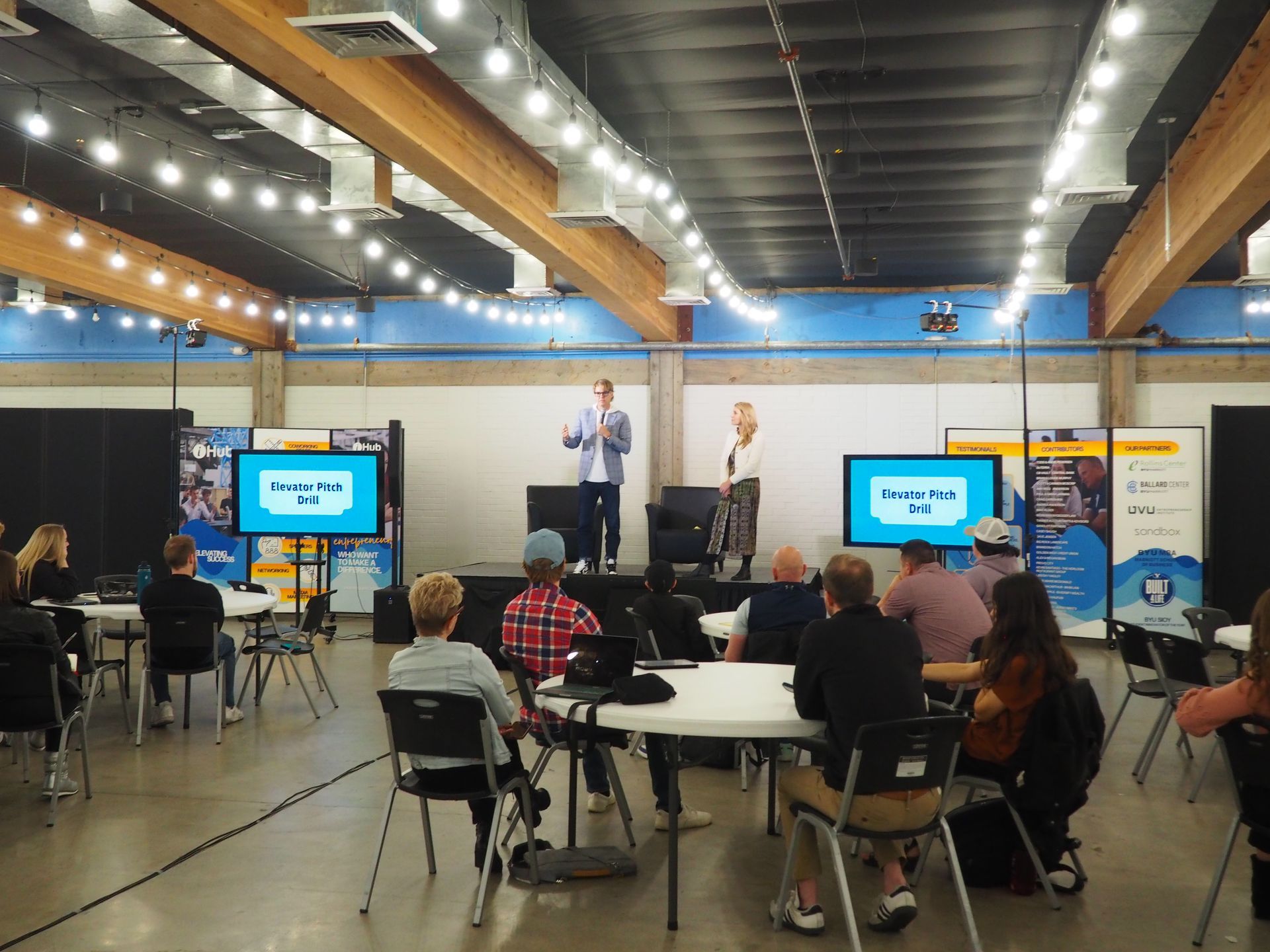 A classroom with tables and chairs set up for a meeting
