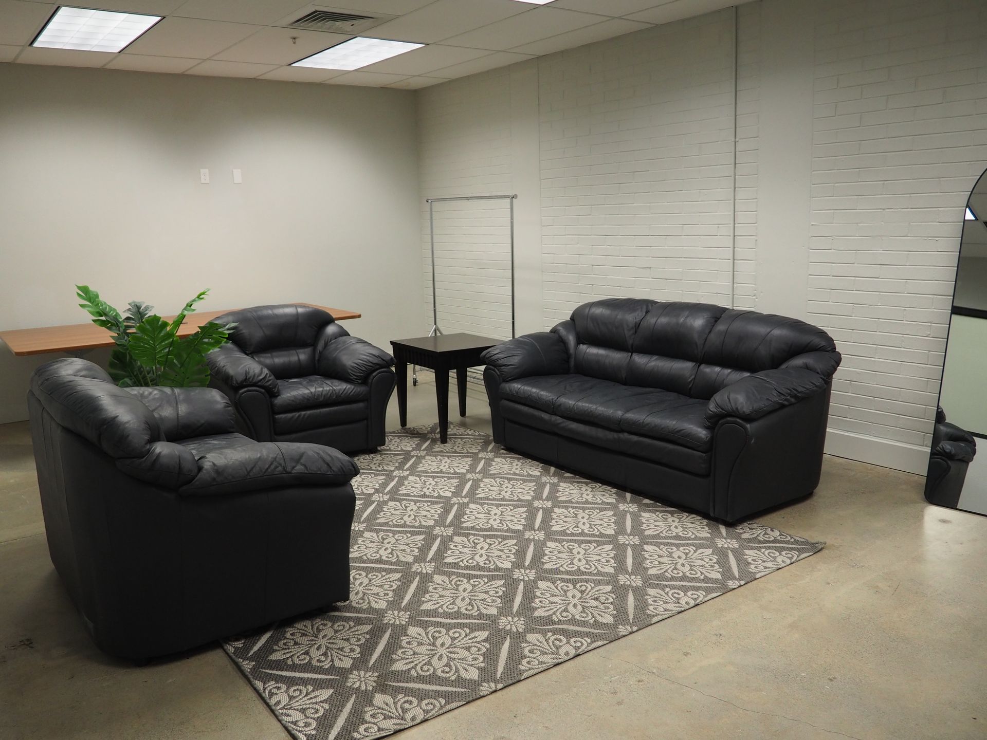 Two women are holding a wedding dress in a room.