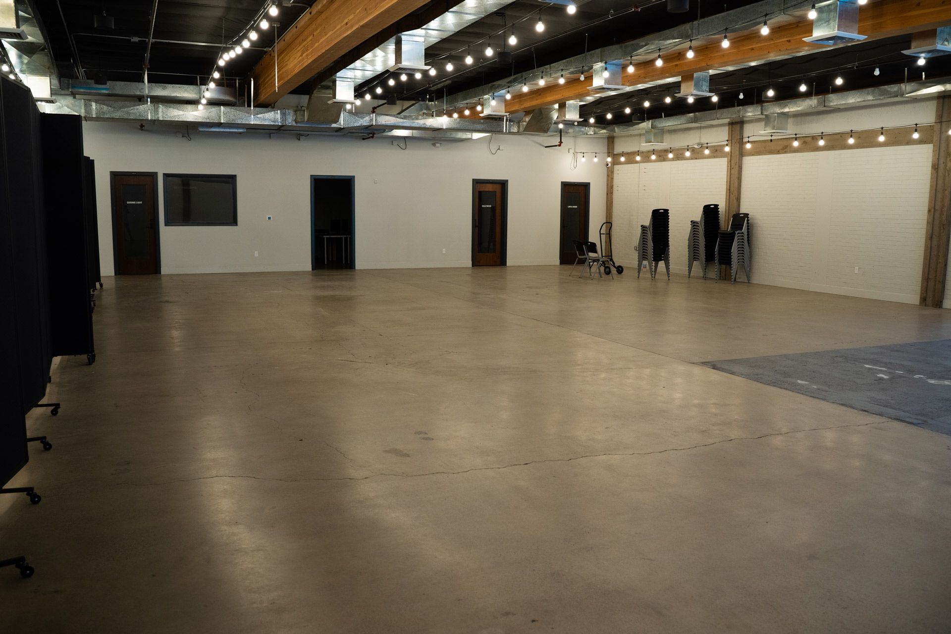 A large empty room with chairs and tables in it.