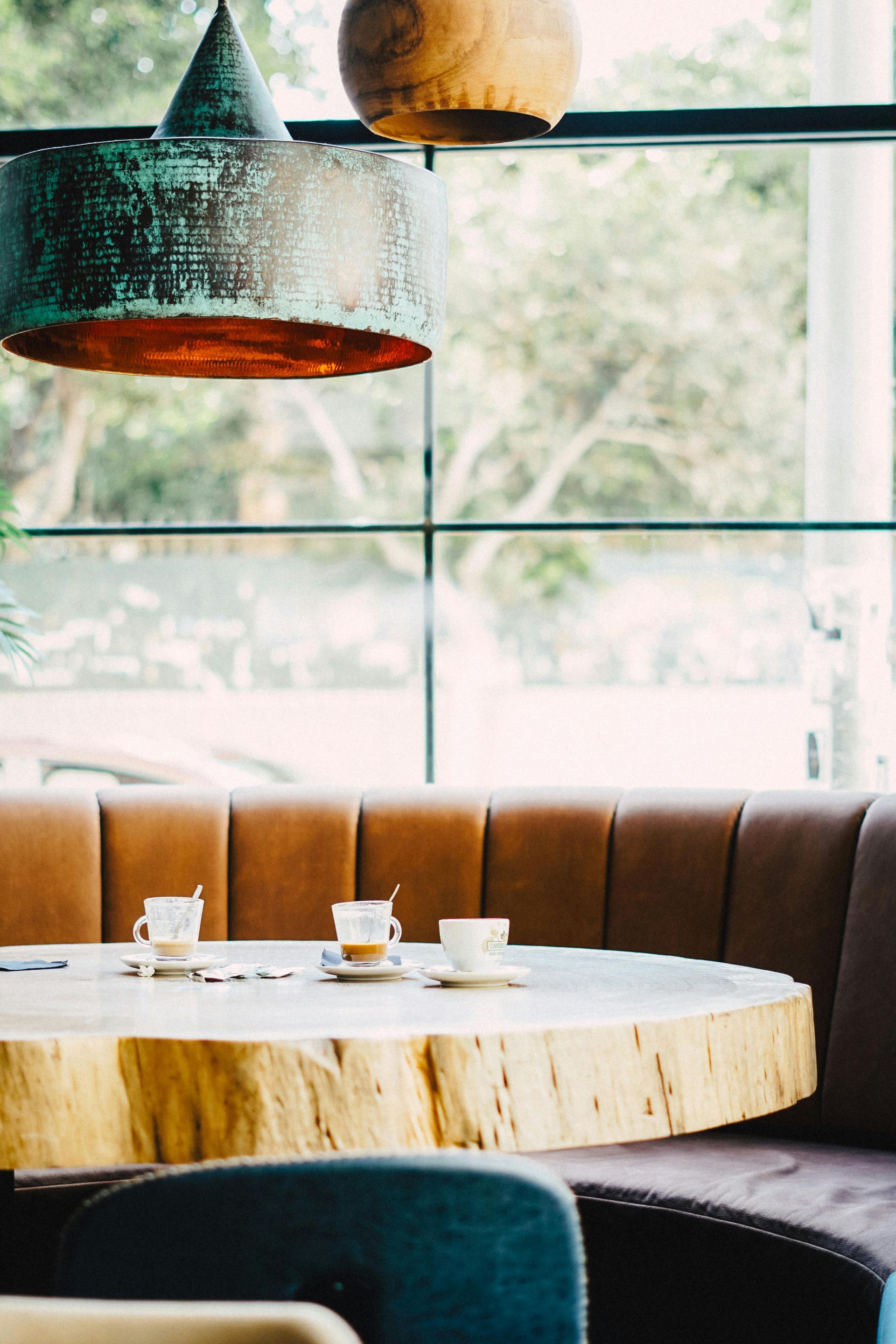 A restaurant with a wooden table and a couch.