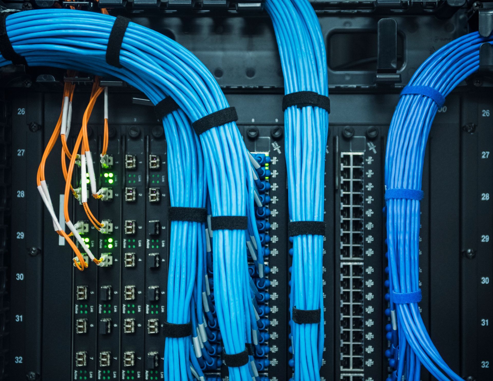 A bunch of blue wires are connected to a server