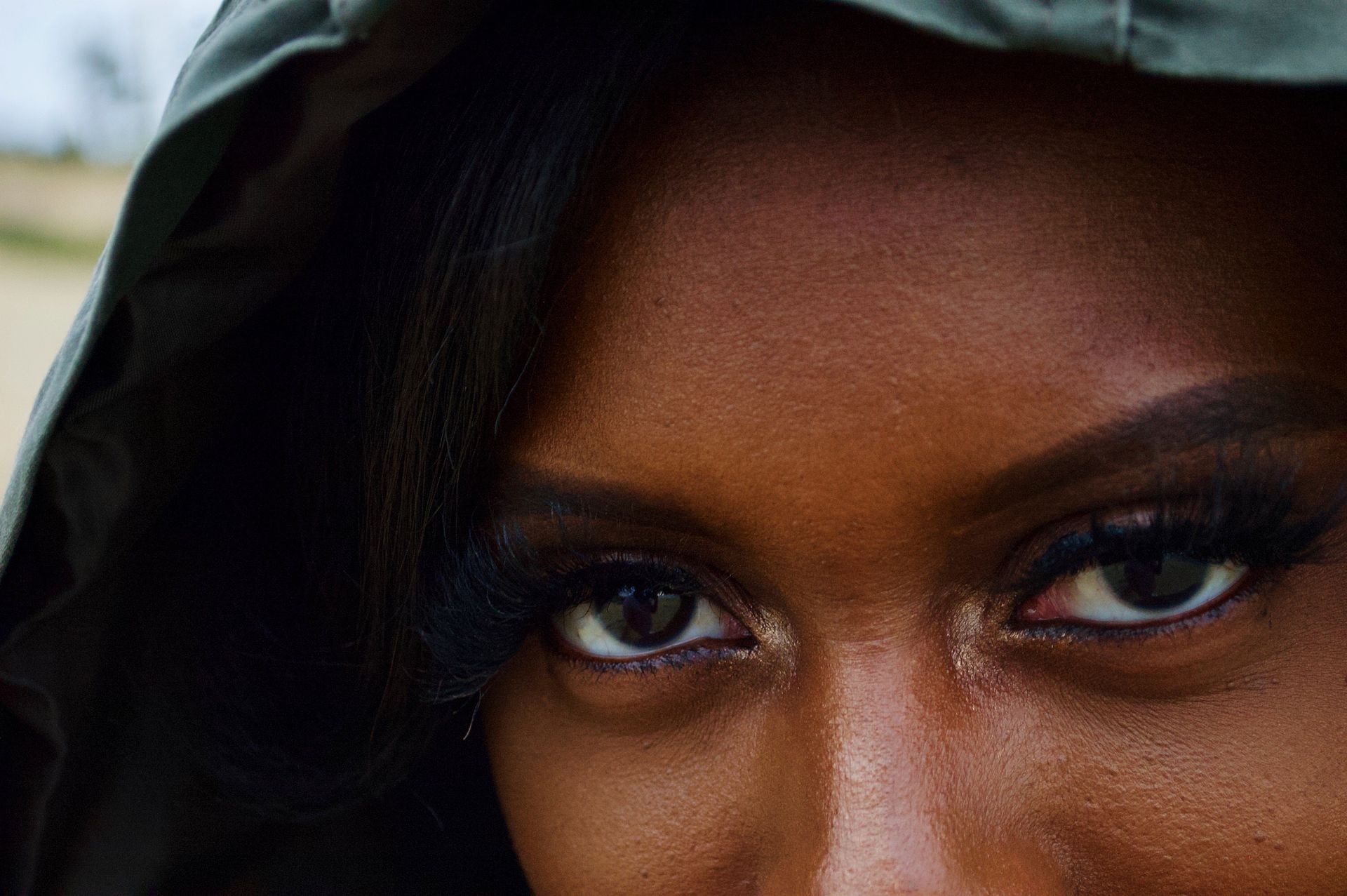 A close up of a woman 's face with her eyes closed.