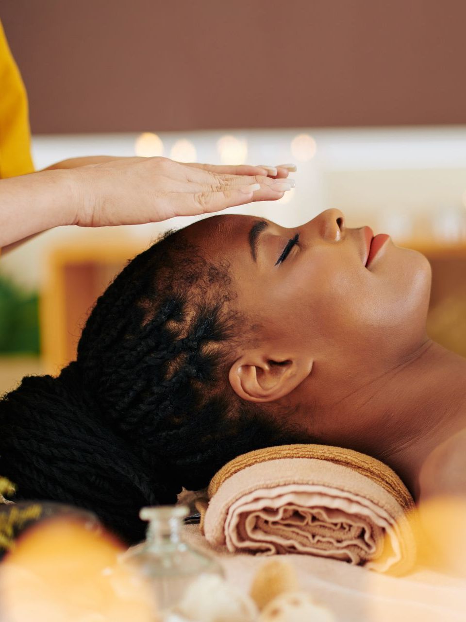 A woman is getting a massage at a spa with her eyes closed.