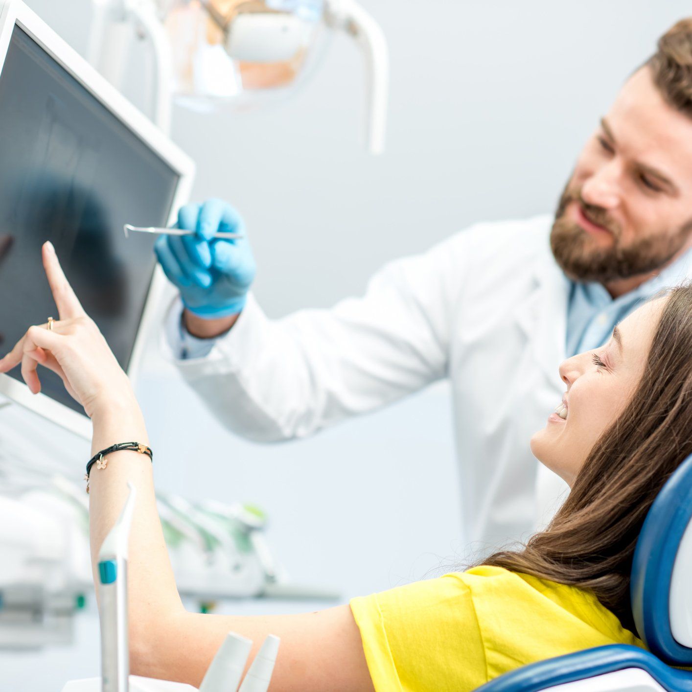 A Dentist Explaining to a Customer — Chicago Heights, IL — Midtown Dental Clinic