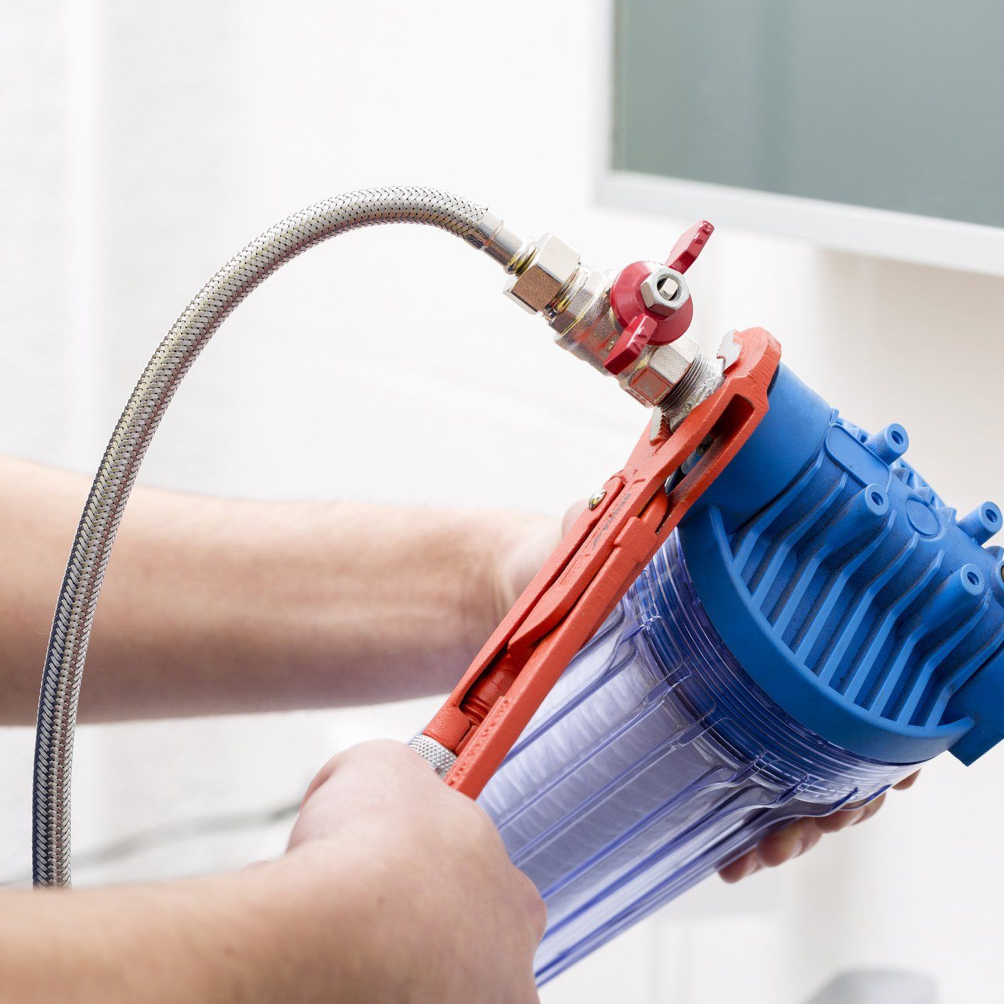 Plumber Installing Water Filter — Orlando, FL — Florida Pure Water Services Plumber Installing Water Filter — Orlando, FL — Florida Pure Water Services