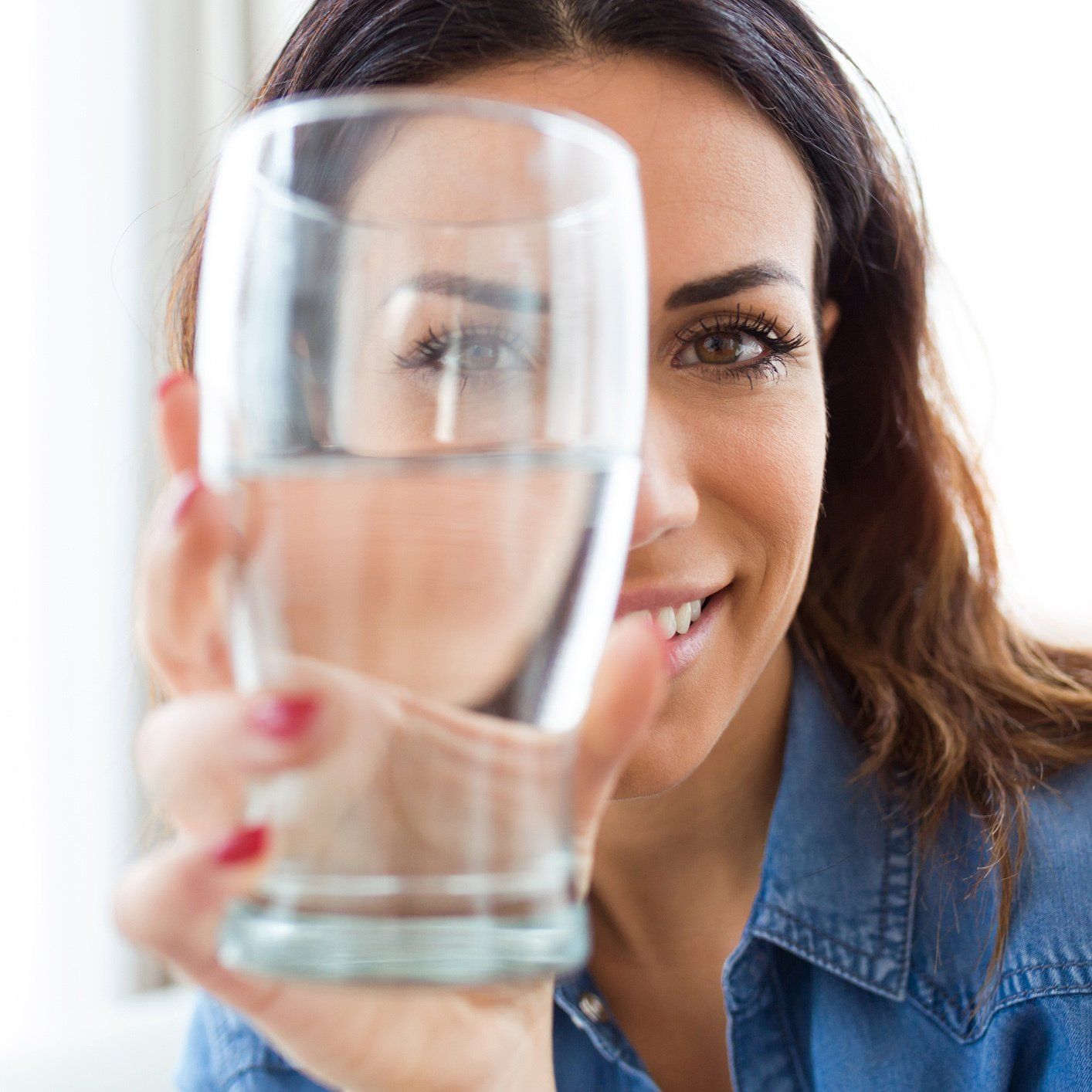 Smiling Woman Holding a Glass of Water — Orlando, FL — Florida Pure Water Services Smiling Woman Holding a Glass of Water — Orlando, FL — Florida Pure Water Services