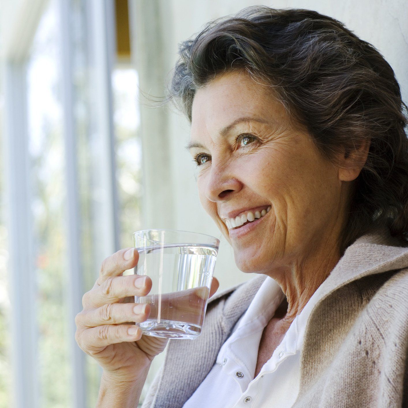 Senior Woman Holding a Glass of Water — Orlando, FL — Florida Pure Water Services Senior Woman Holding a Glass of Water — Orlando, FL — Florida Pure Water Services