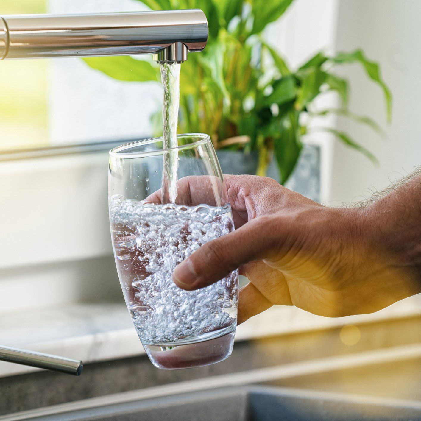 Water Poured From Kitchen Faucet — Orlando, FL — Florida Pure Water Services