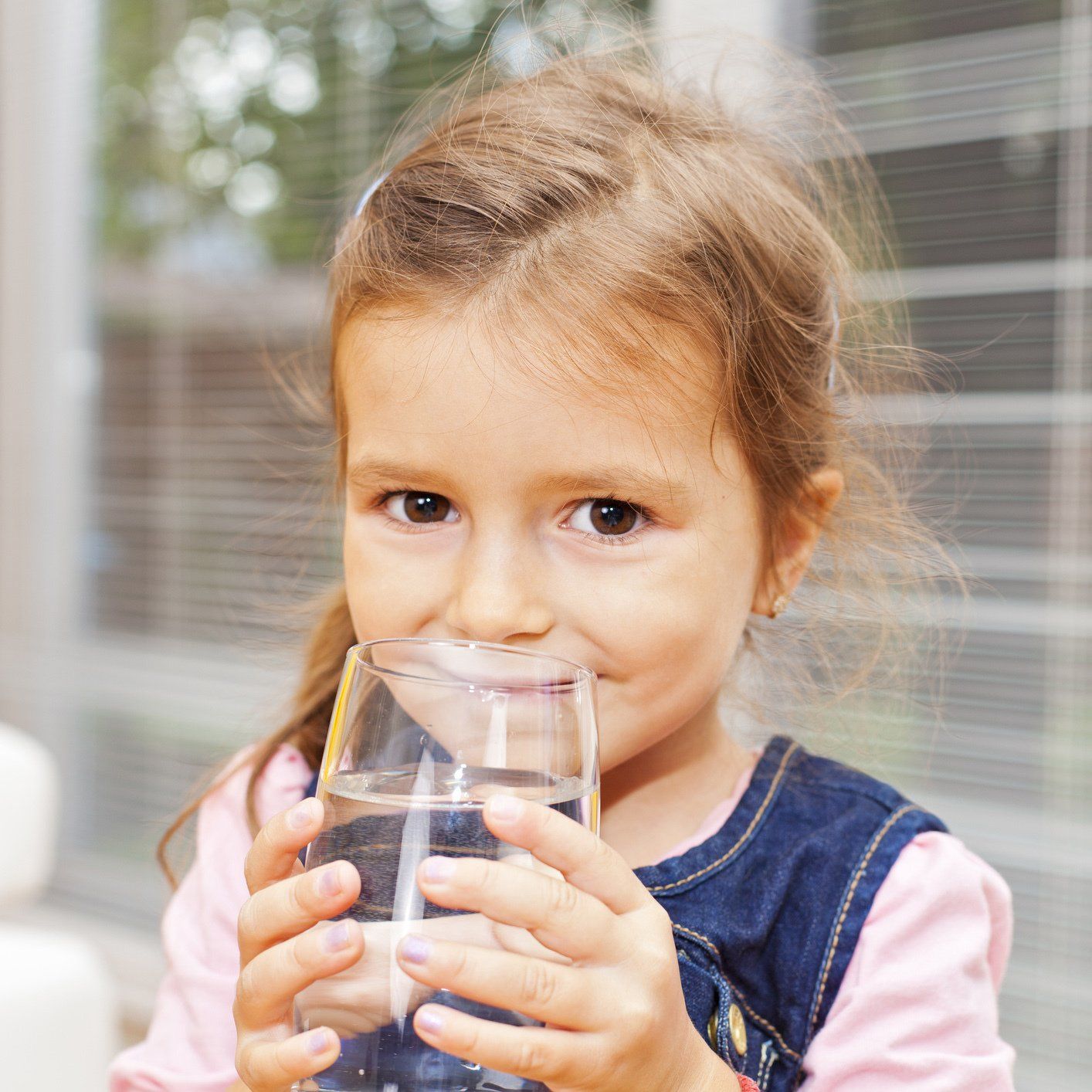 Young Girl Drinking a Glass of Water — Orlando, FL — Florida Pure Water Services