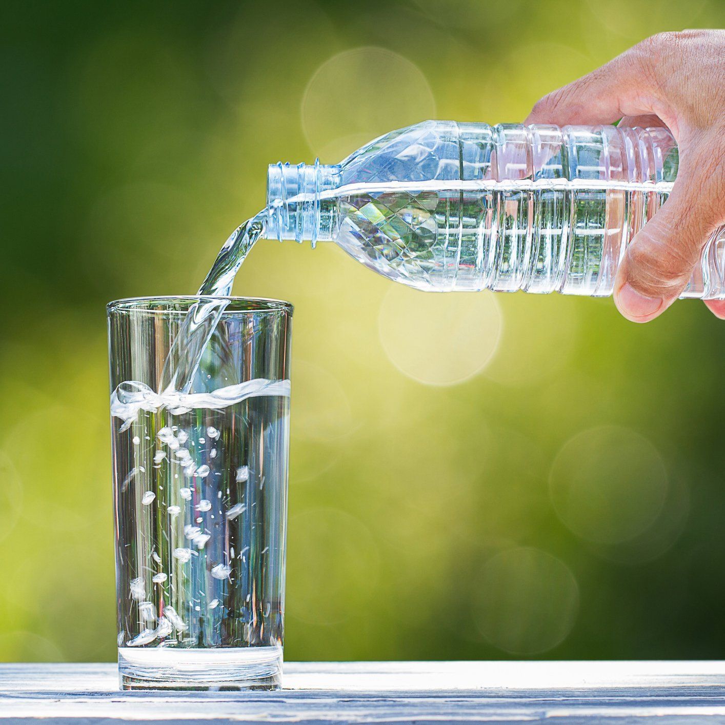 Man Pouring Water Into Glass — Orlando, FL — Florida Pure Water Services