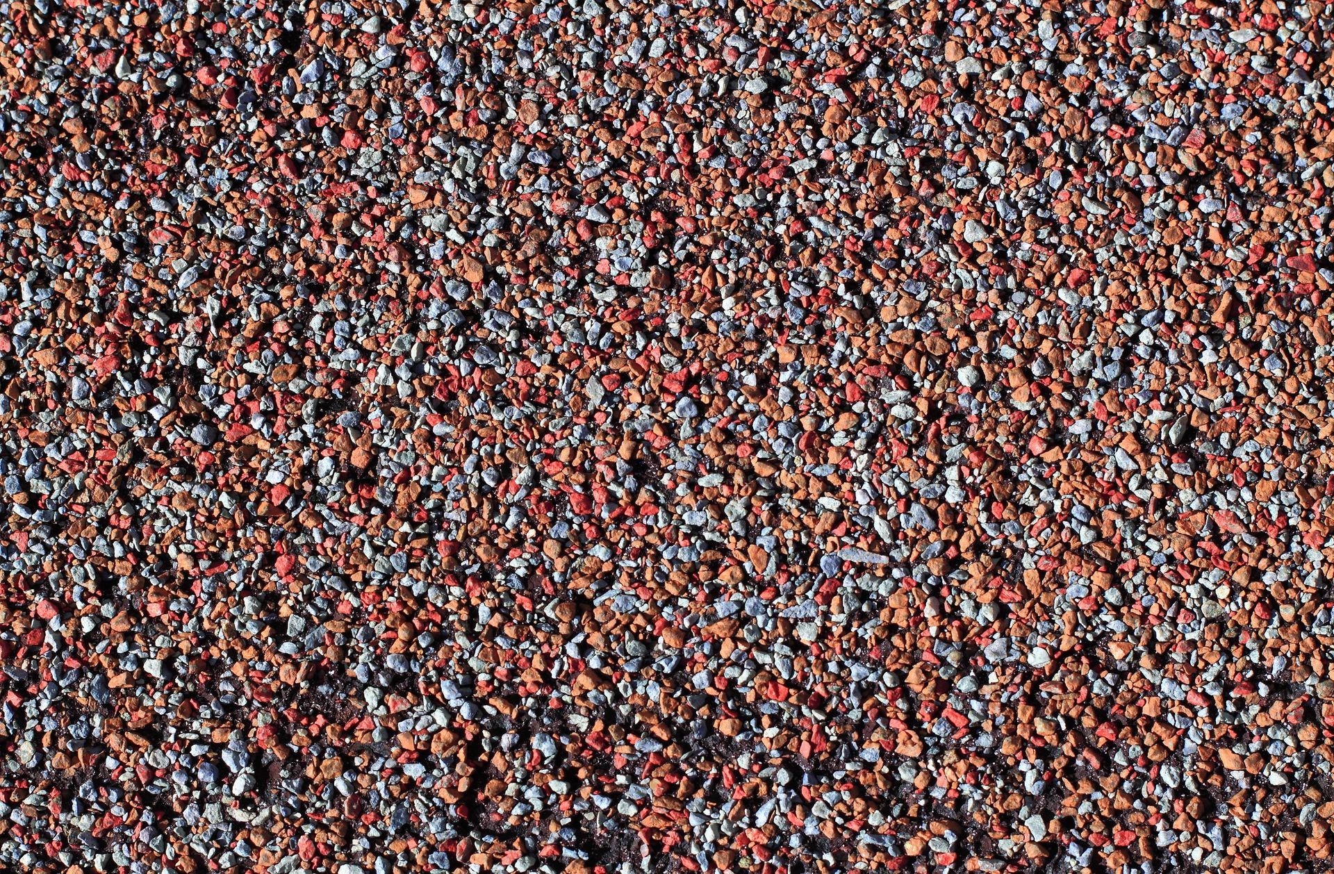 Close-up of loose asphalt shingle granules from roof wear