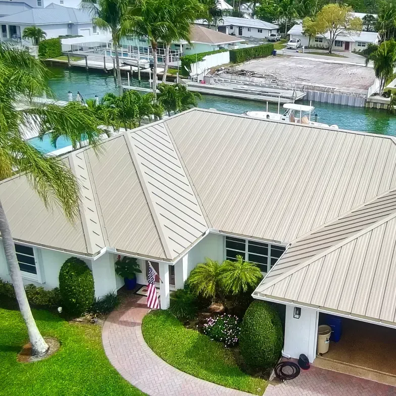 Cream-colored metal roof on a Florida waterfront home