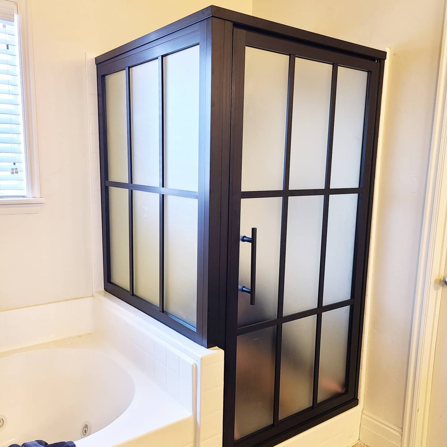 A bathroom with a bathtub and a shower stall