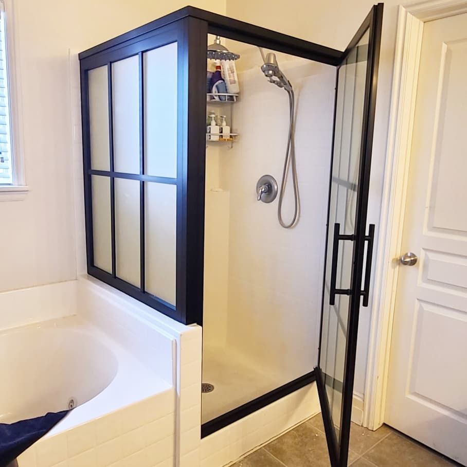 A bathroom with a bathtub and a shower stall