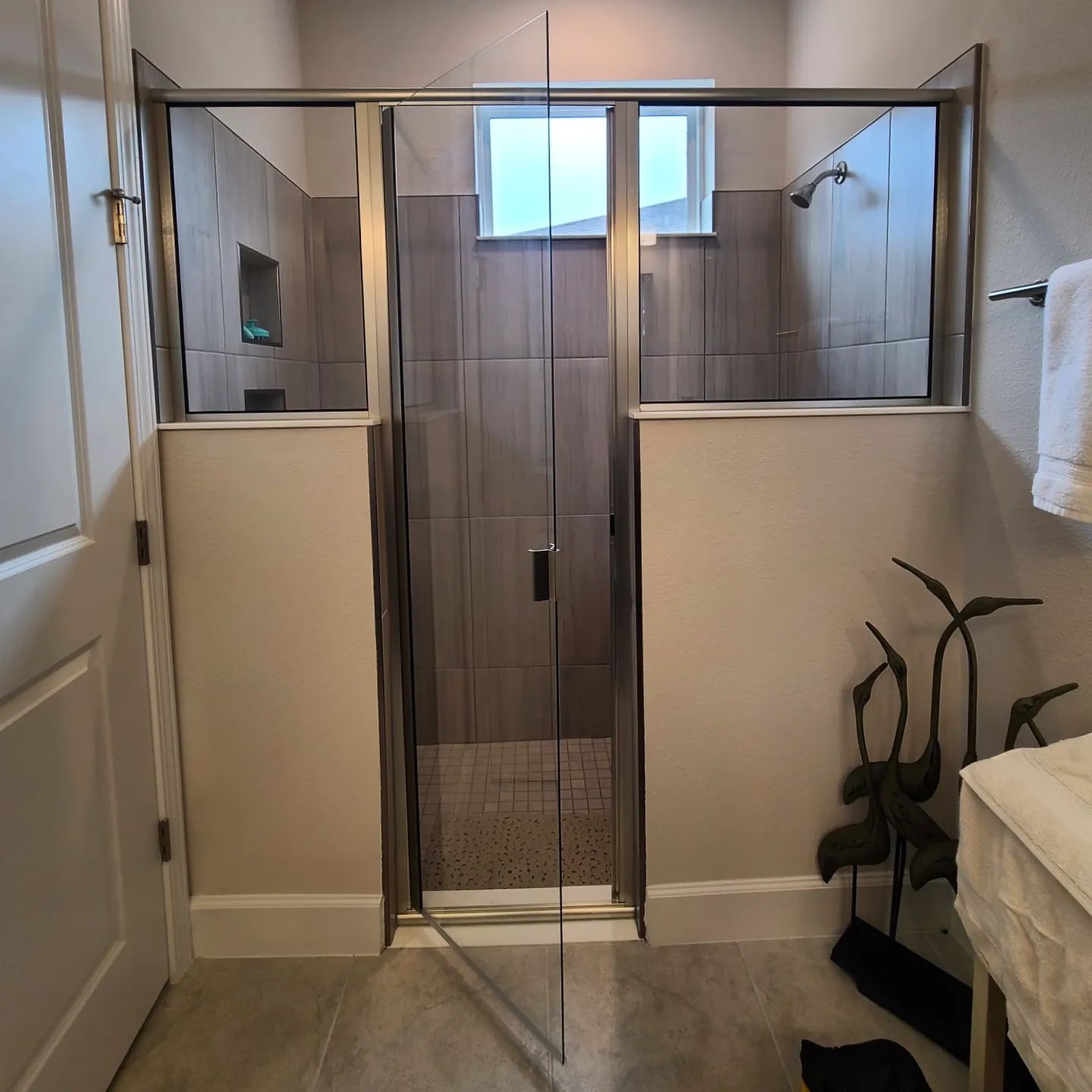 A bathroom with a sliding glass shower door