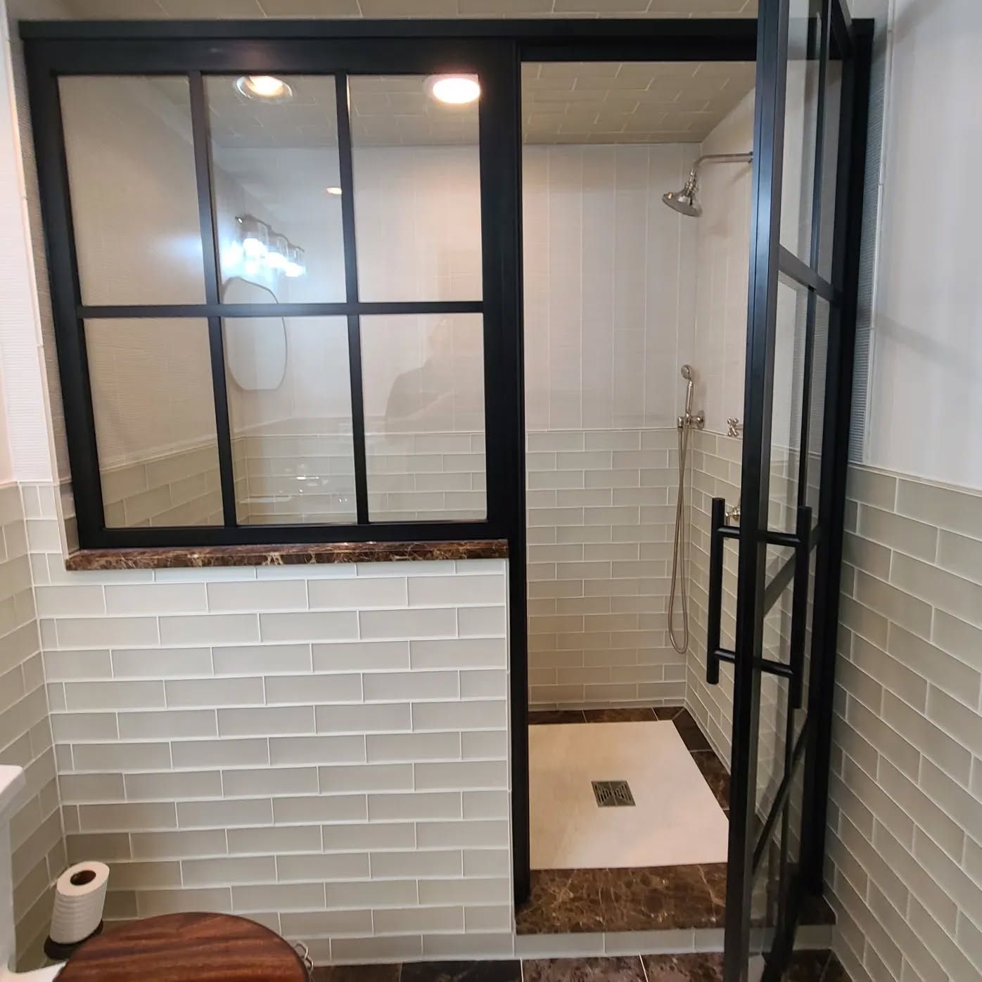 A bathroom with a toilet and a walk in shower