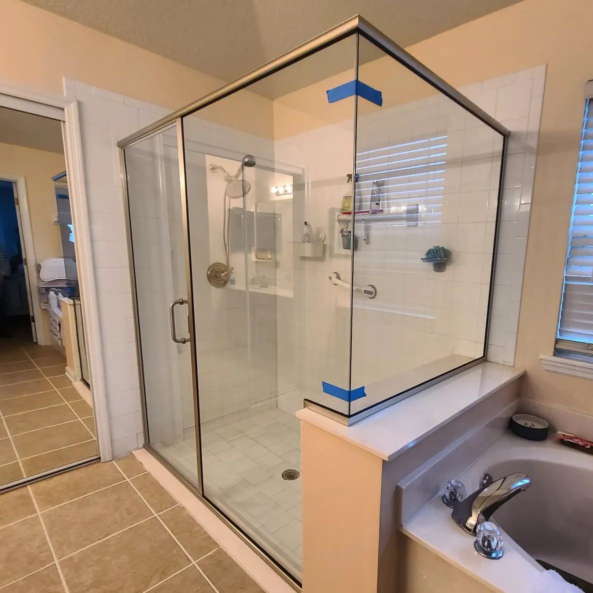 A bathroom with a walk in shower and a bathtub