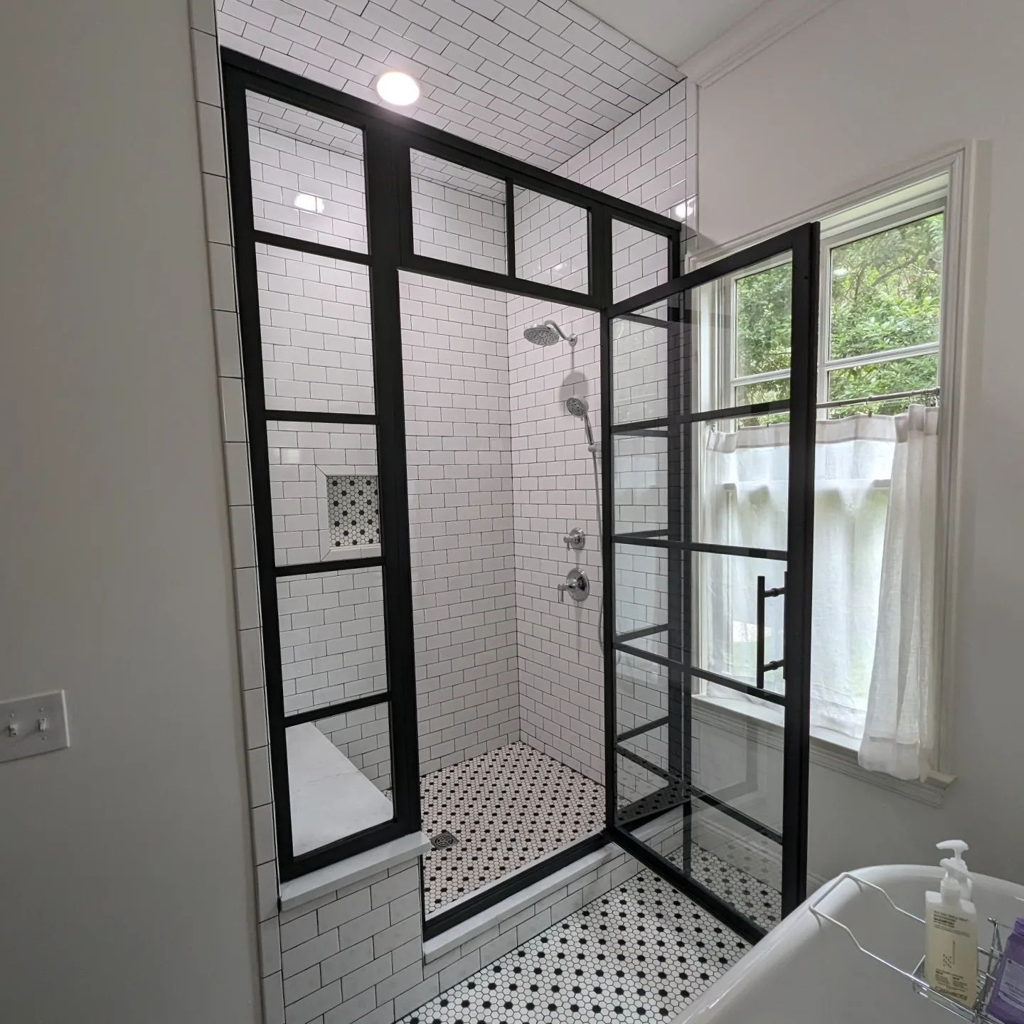 A bathroom with a walk in shower and a bathtub.