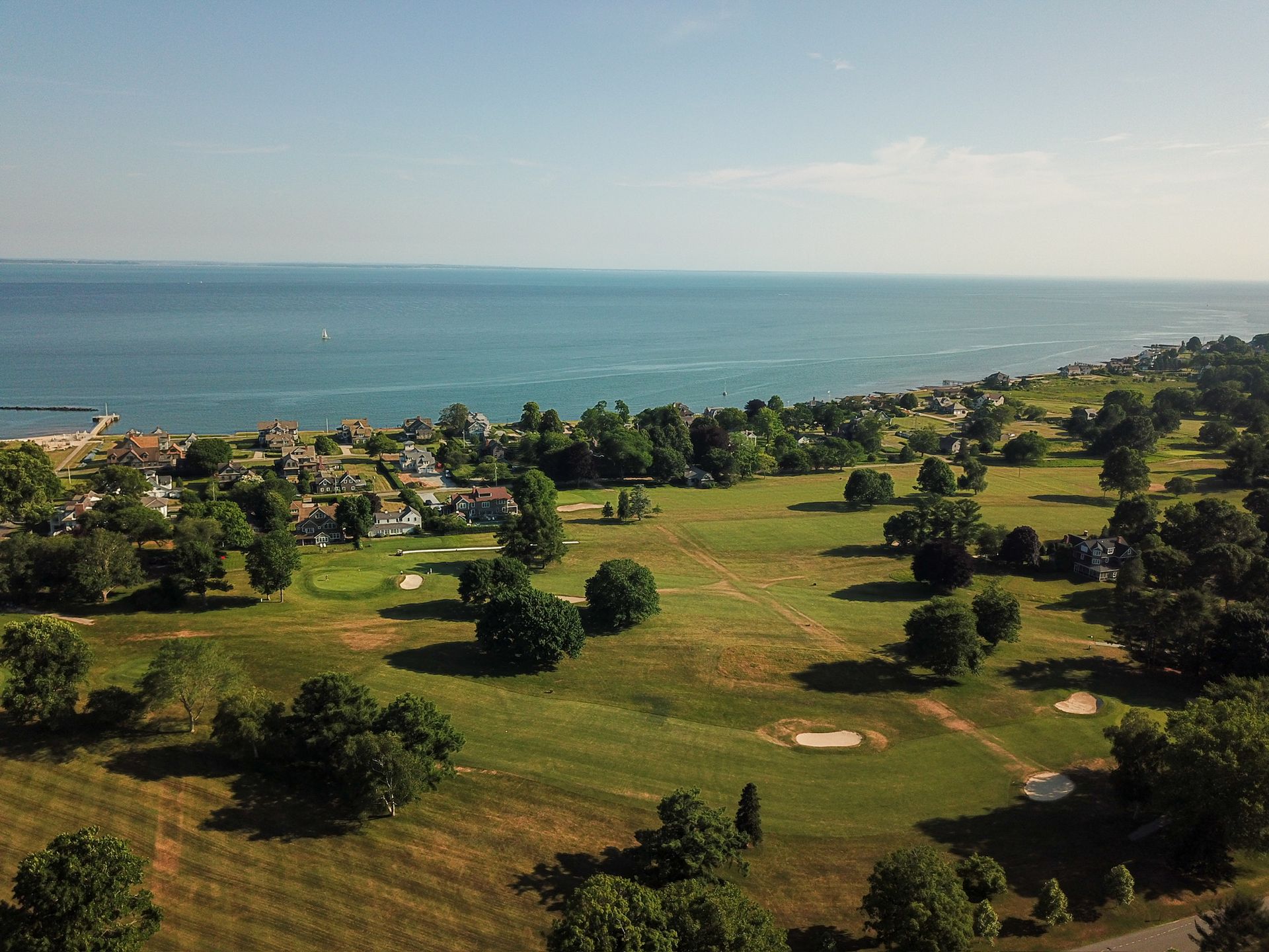 An aerial view of a golf course next to the ocean.