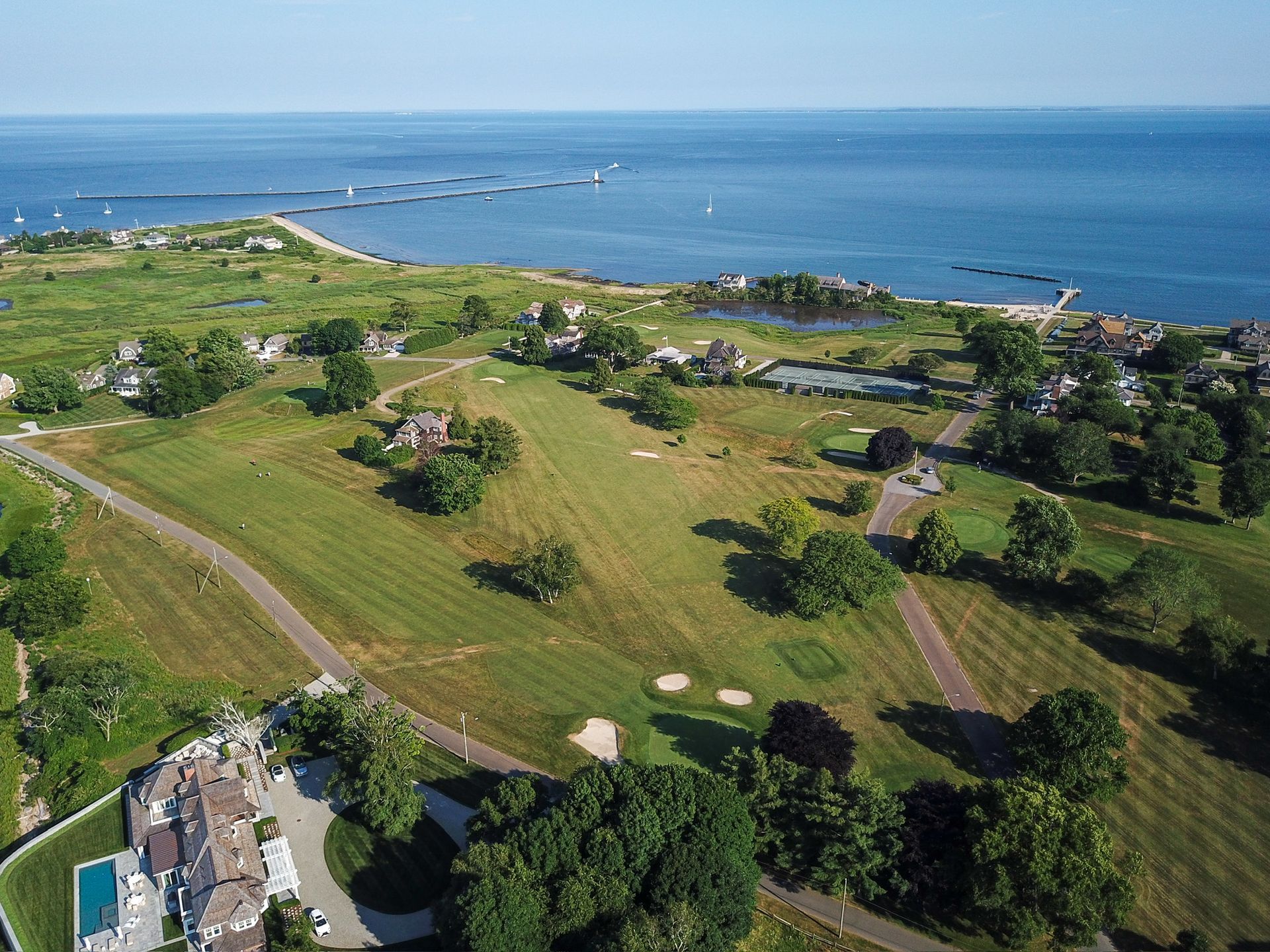 An aerial view of a golf course next to the ocean.