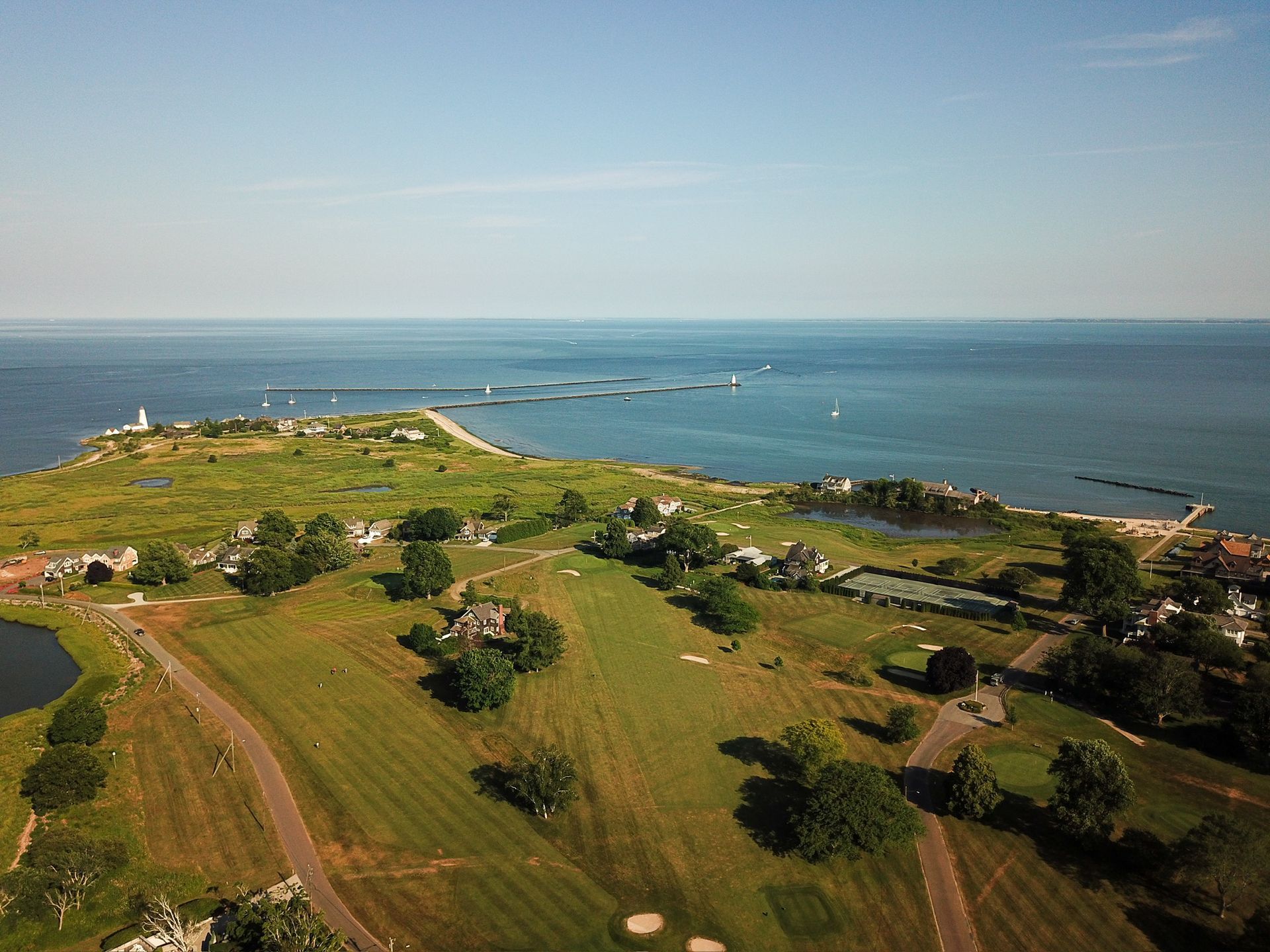 An aerial view of a golf course next to the ocean.