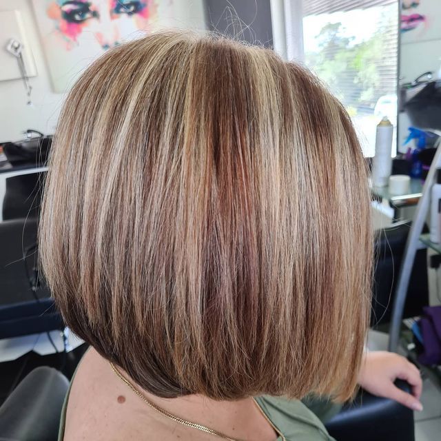A Woman is Sitting in a Chair With Her Hair in a Bob — Lush Hair Studio in Tumbi Umbi, NSW