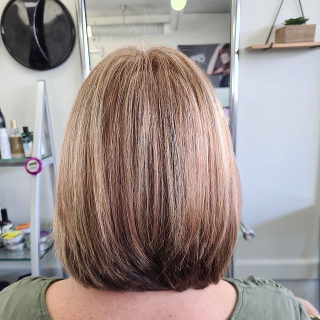 The Back of a Woman's Hair is Shown in Front of a Mirror — Lush Hair Studio in Tumbi Umbi, NSW