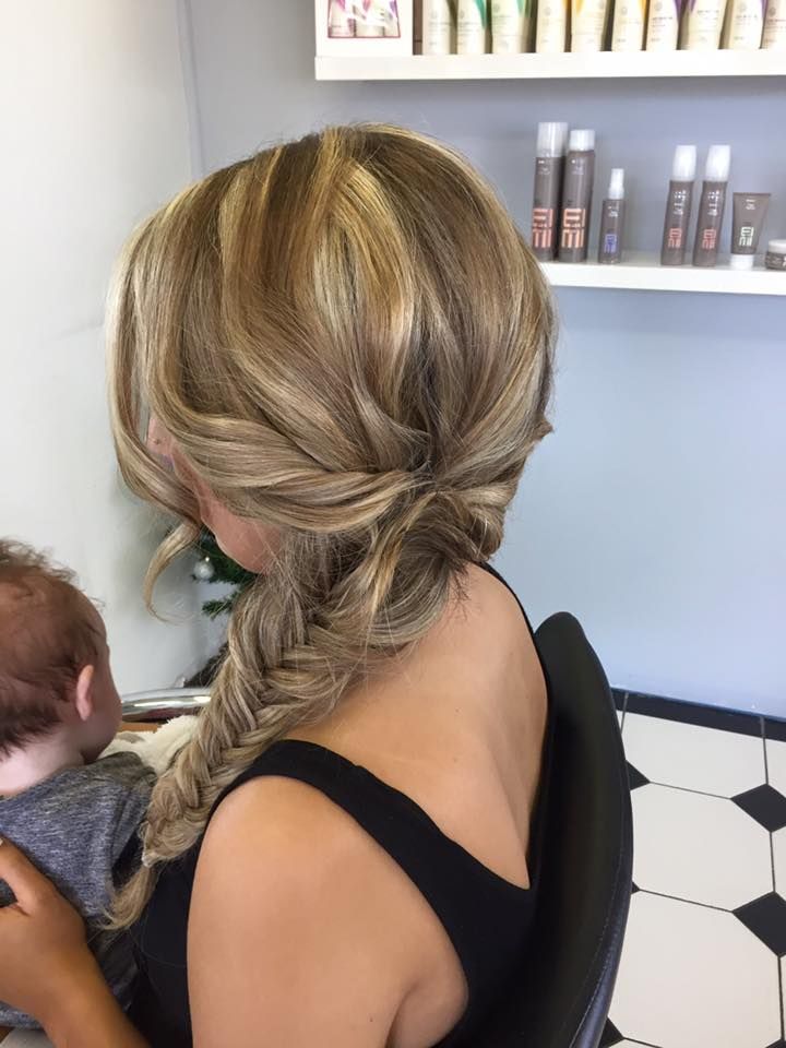 A Woman is Sitting in a Chair With Her Hair in a Braid — Lush Hair Studio in Tumbi Umbi, NSW