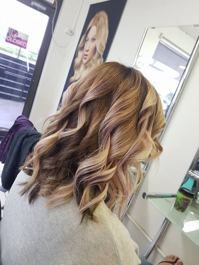 A Woman is Sitting in a Chair With Her Hair in a Salon — Lush Hair Studio in Tumbi Umbi, NSW