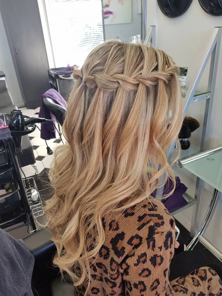 A Woman is Getting Her Hair Braided in a Salon — Lush Hair Studio in Tumbi Umbi, NSW