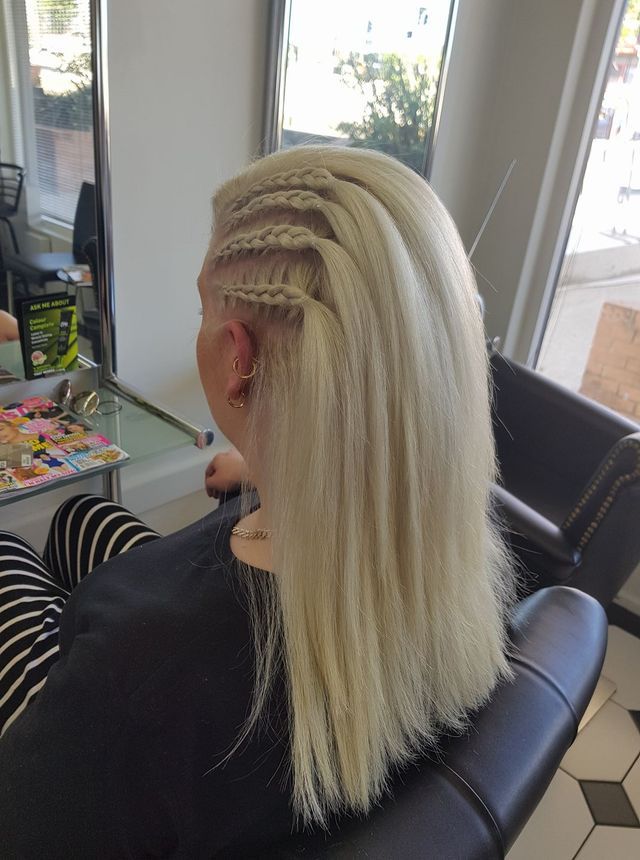 A Woman With Blonde Hair is Sitting in a Chair in a Salon — Lush Hair Studio in Tumbi Umbi, NSW
