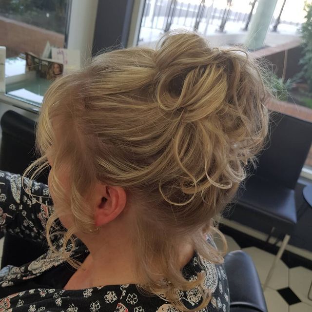 A Woman With Blonde Hair in a Messy Bun — Lush Hair Studio in Tumbi Umbi, NSW
