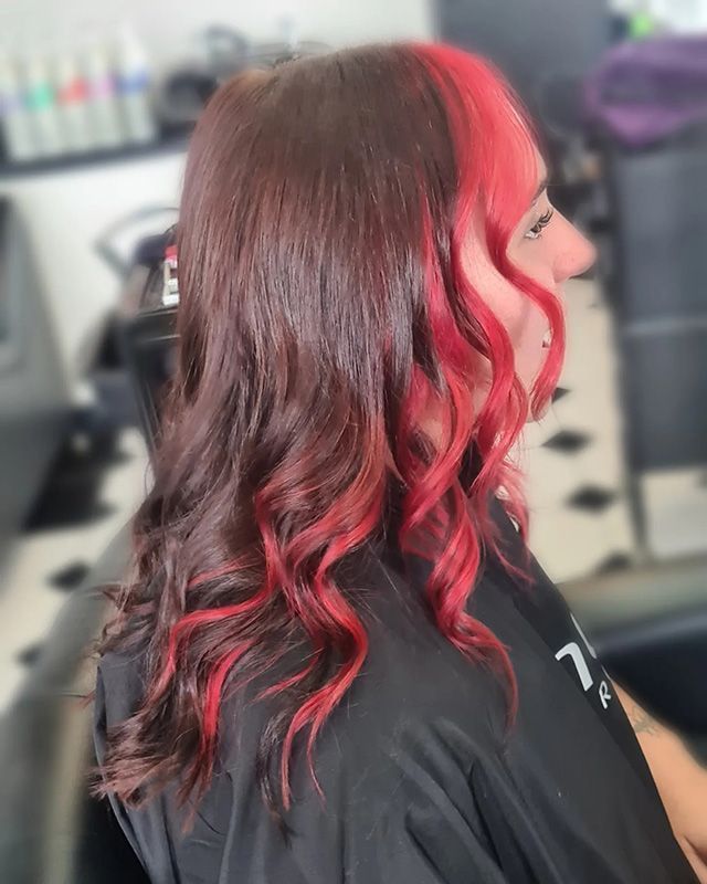 A Woman With Red Hair is Sitting in a Chair in a Salon — Lush Hair Studio in Tumbi Umbi, NSW