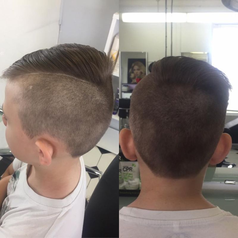 A Boy is Getting His Hair Cut in Front of a Mirror — Lush Hair Studio in Tumbi Umbi, NSW