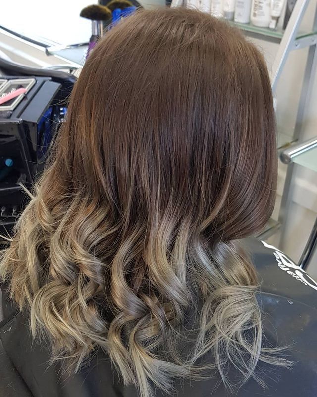 A Woman is Sitting in a Chair With Her Hair in a Salon — Lush Hair Studio in Tumbi Umbi, NSW