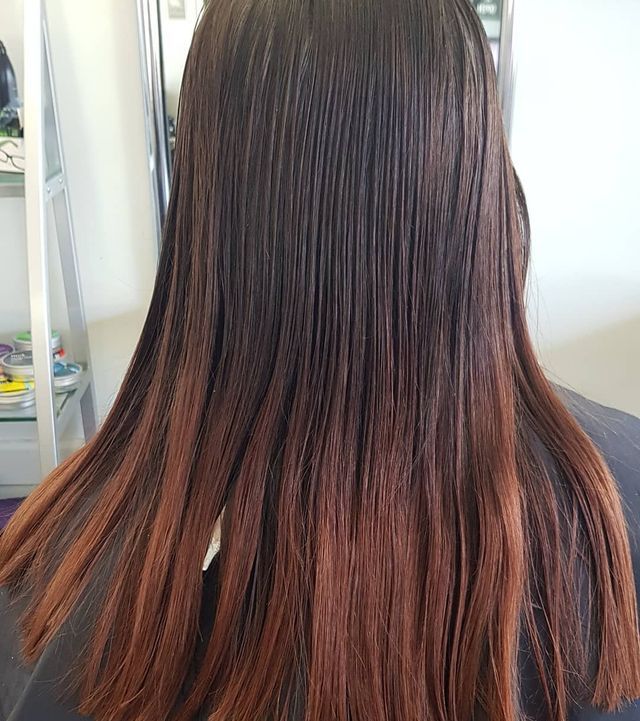 A Woman With Long Brown Hair is Sitting in a Chair — Lush Hair Studio in Tumbi Umbi, NSW