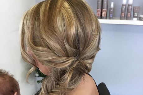A Woman is Wearing Her Hair in a Braided Bun — Lush Hair Studio in Tumbi Umbi, NSW