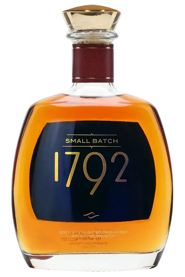 Bottle of 1792 Small Batch bourbon whiskey; gold liquid inside, dark blue label with gold text, clear glass.