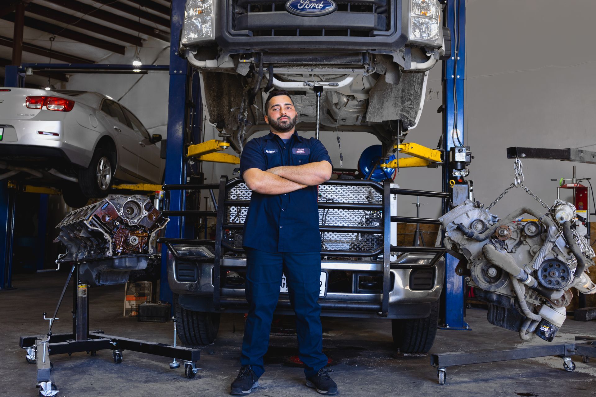 Team Member Standing In Front of Car Being Repaired | Five Star Automotive and Collision