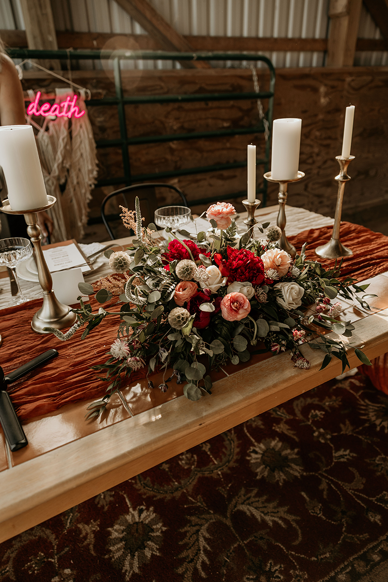 A wedding table decorated with flowers and candles, topped with a
