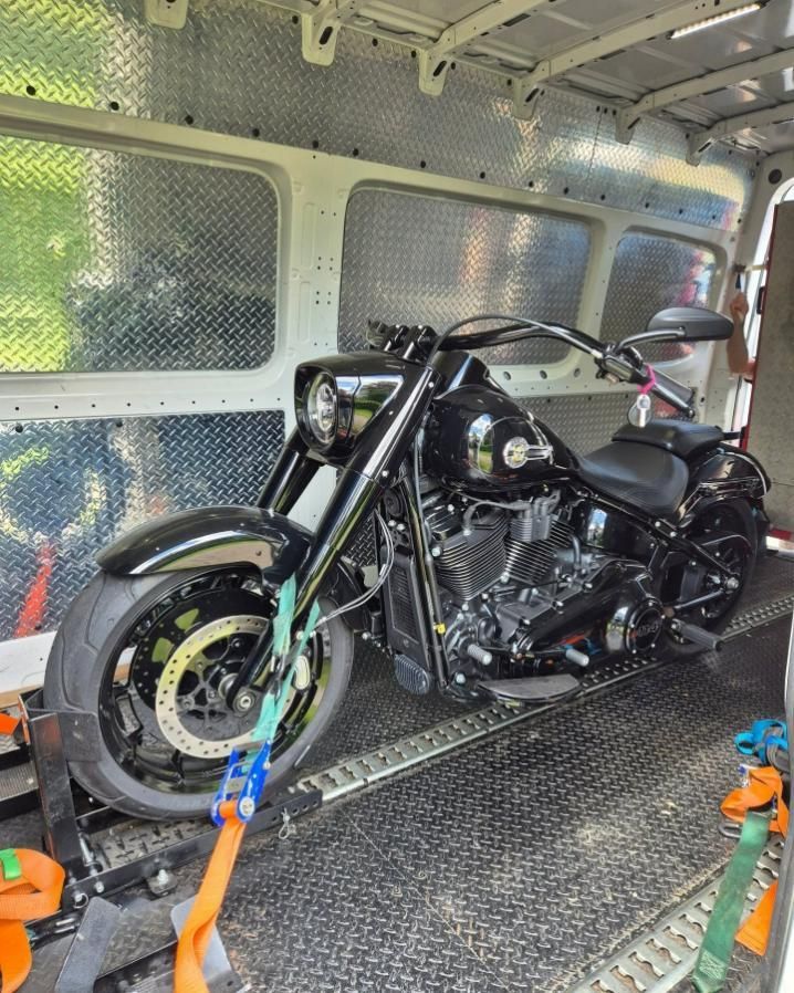 A Black Motorcycle Is Sitting In The Back Of A Van — Motow Motorcycle Transport In Sandgate, NSW